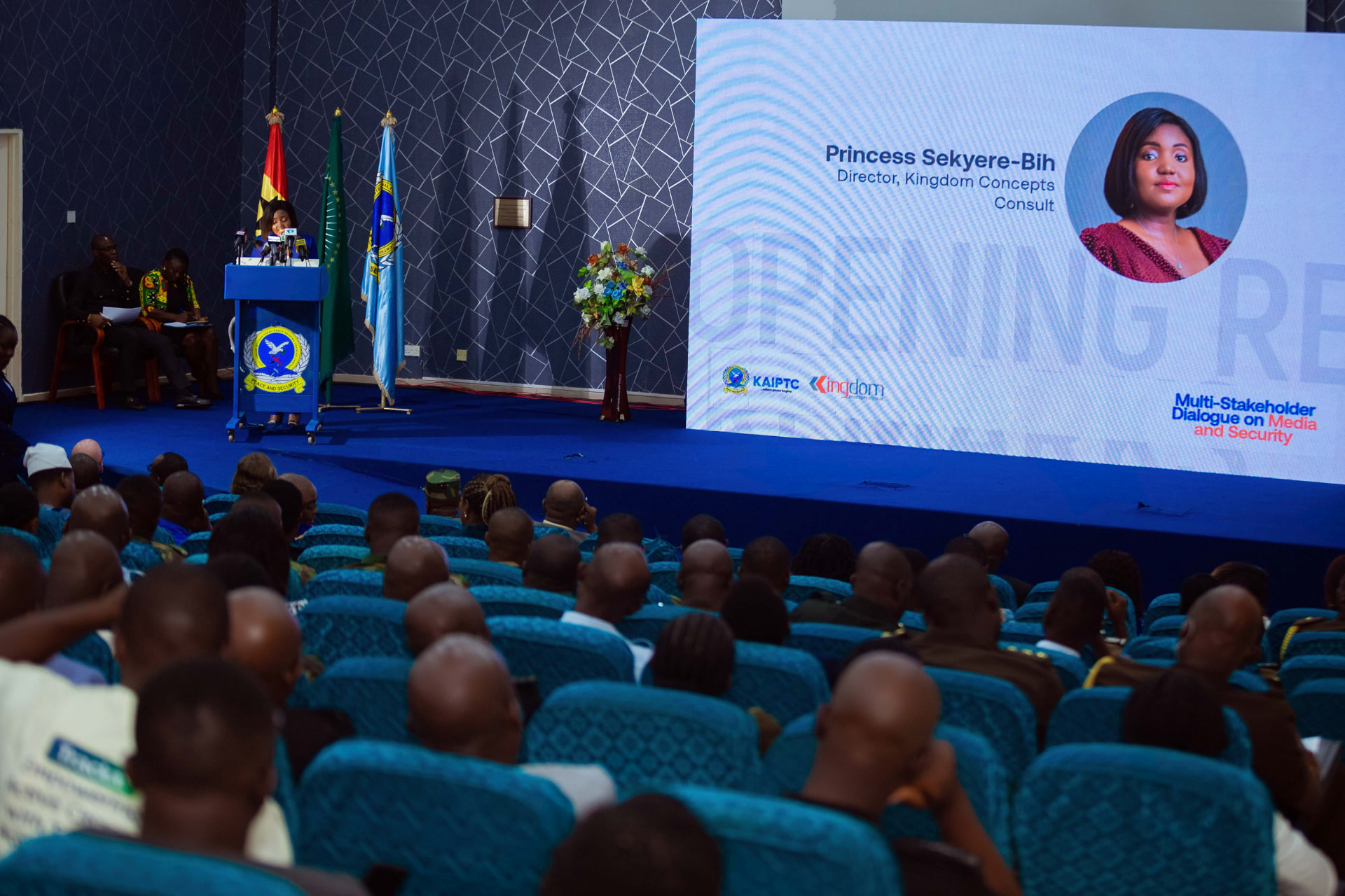 The opening address in the KAIPTC auditorium, with Princess Sekyere-Bih, Director of Kingdom Concepts Consult, shown on the screen beside the KAIPTC and Kingdom Concepts logos
