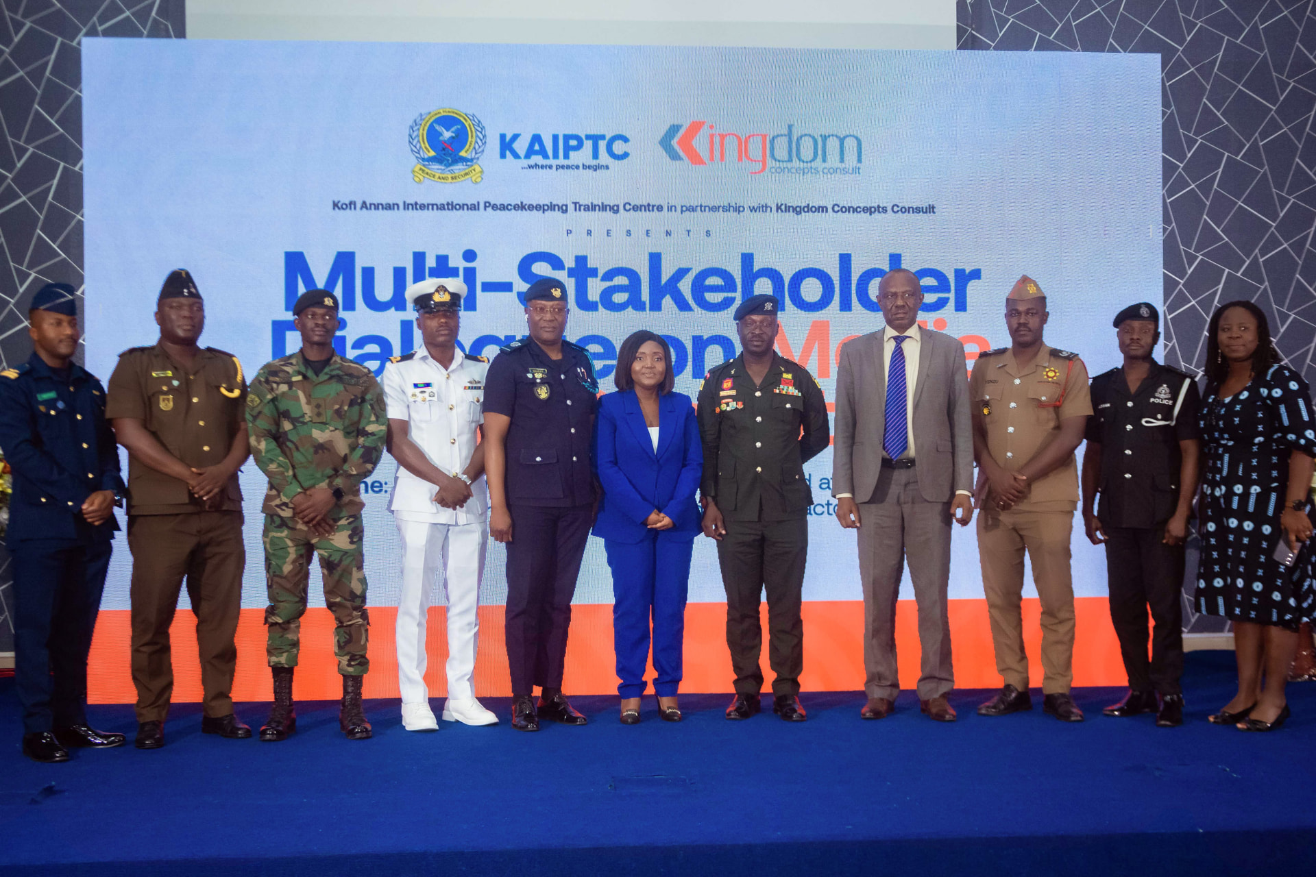 Army, navy, fire service and police representatives pose together on stage