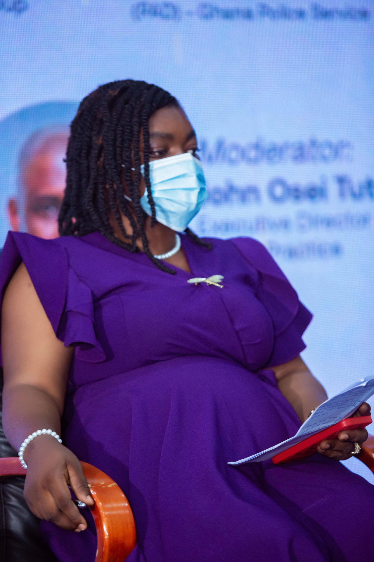 A panellist following the discussion with her remarks in hand
