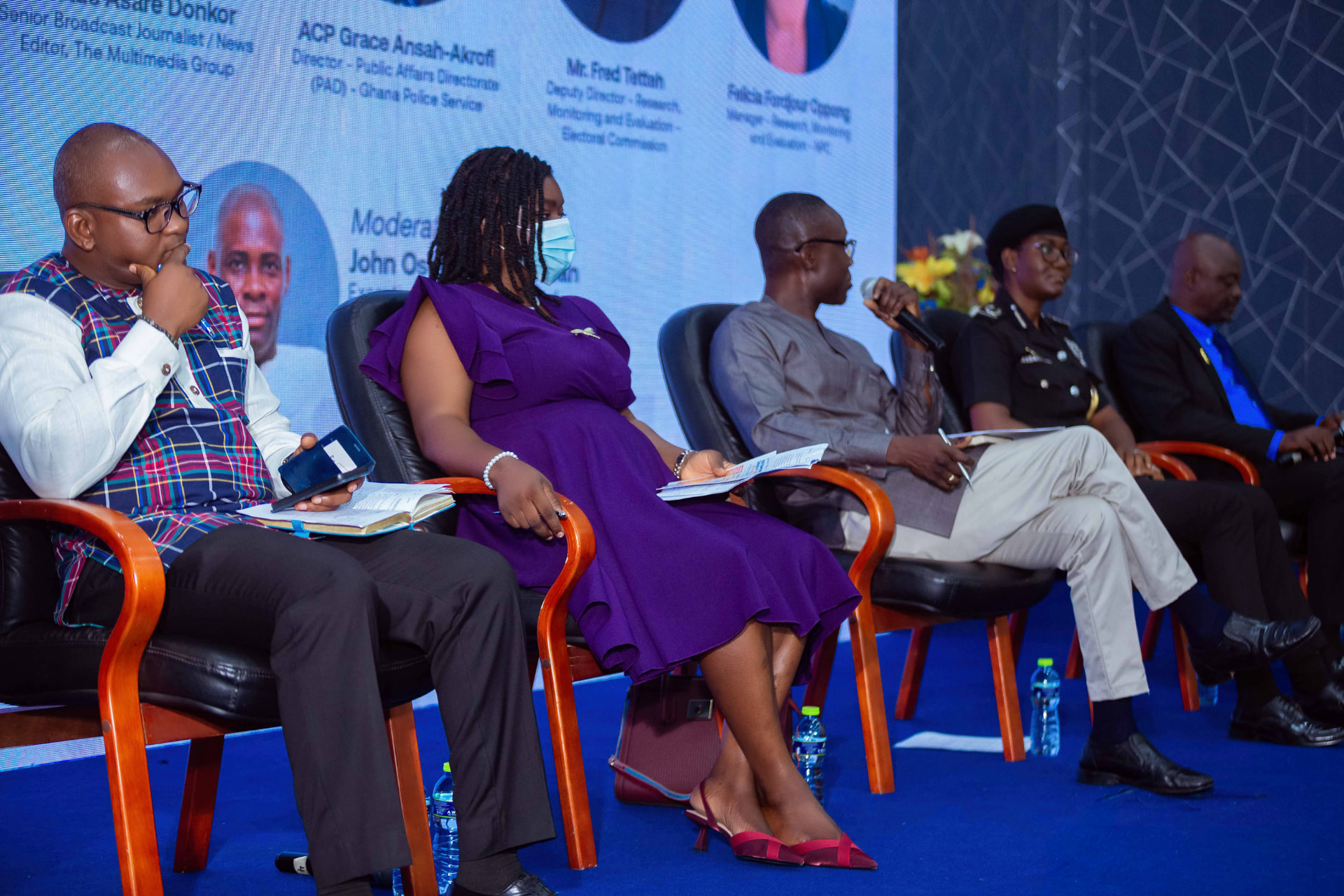 The moderator opening the panel discussion, with the panellists seated beside him