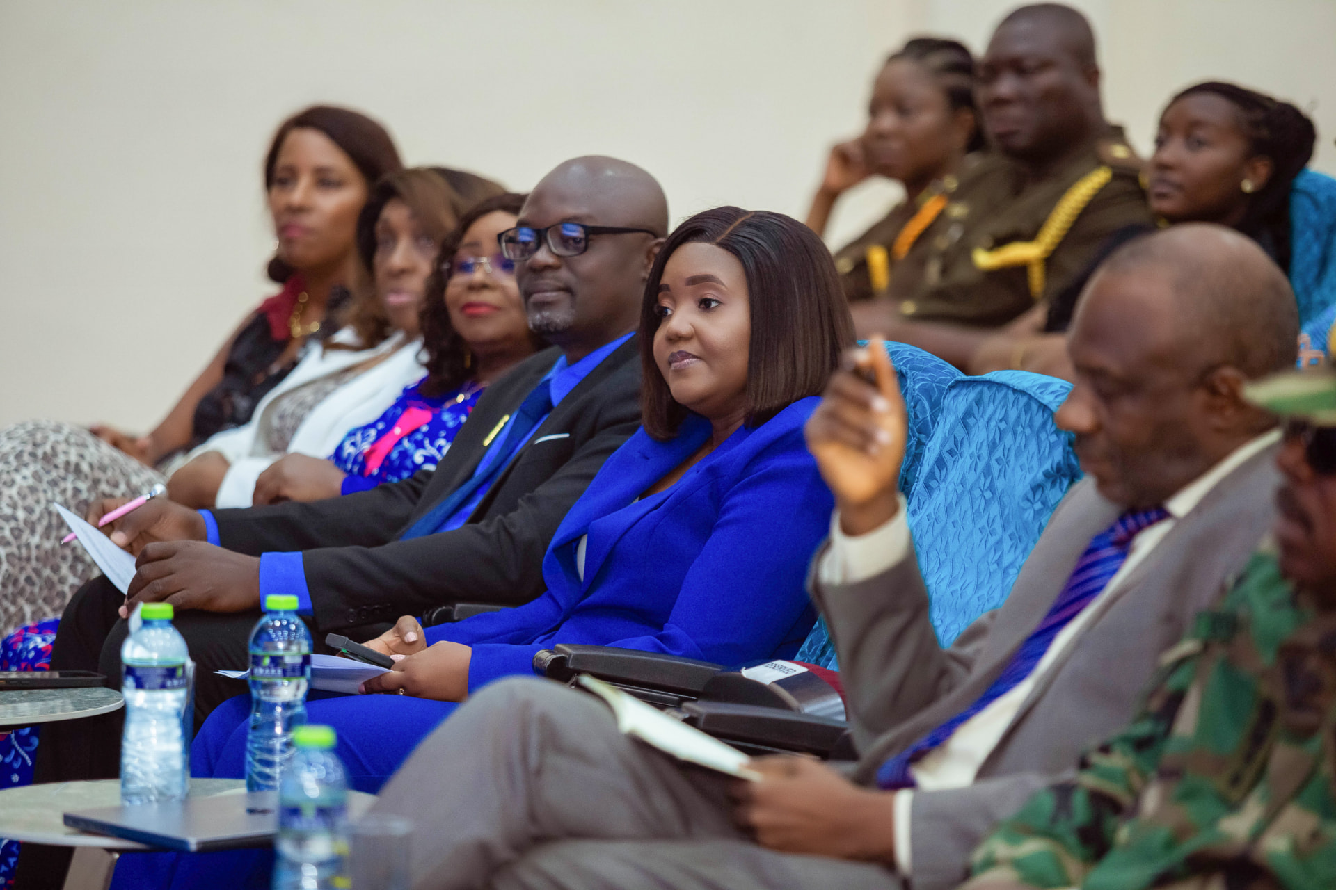 Dignitaries and guests seated in the front rows, listening to the proceedings