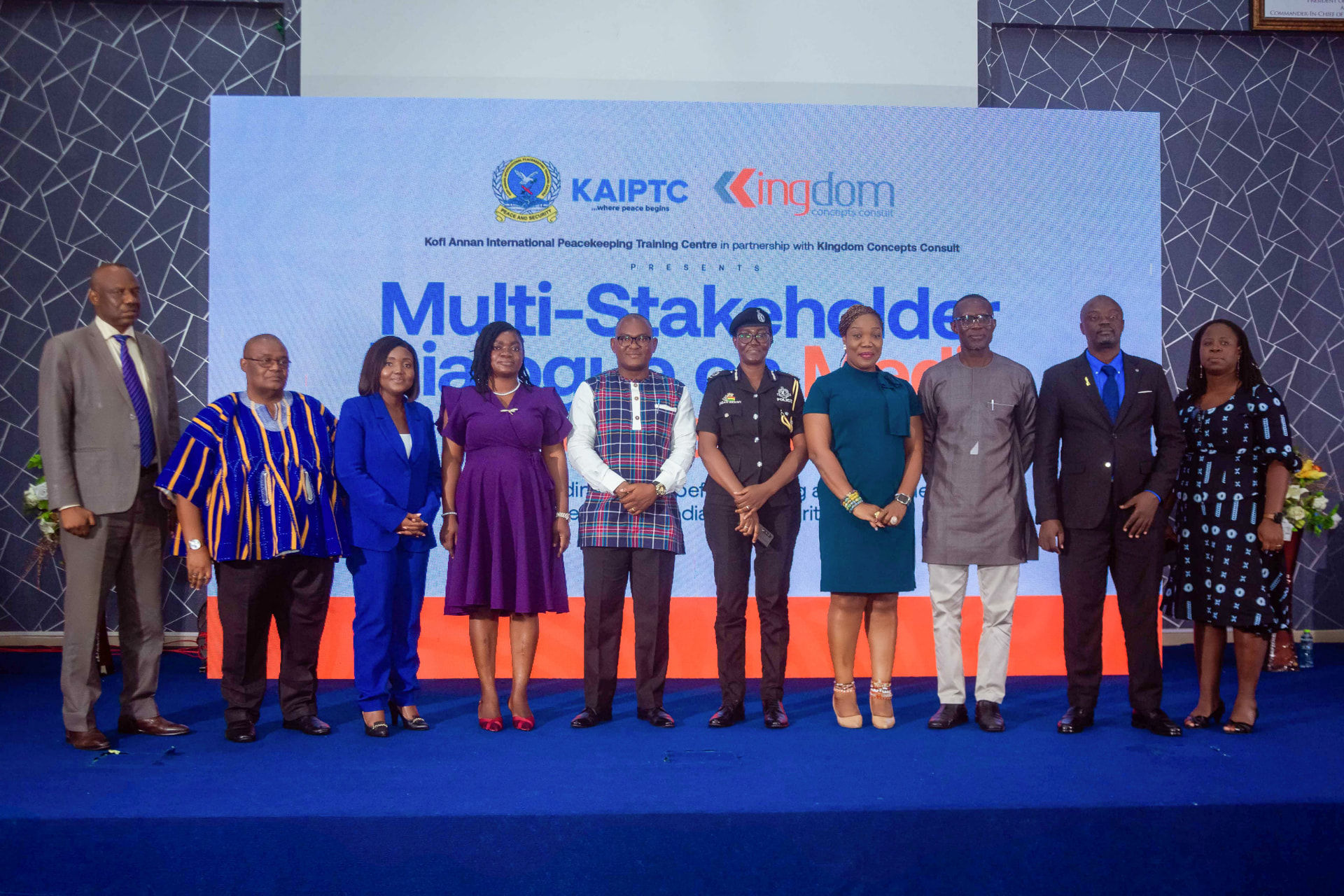 Panellists and organisers pose together on stage after the session